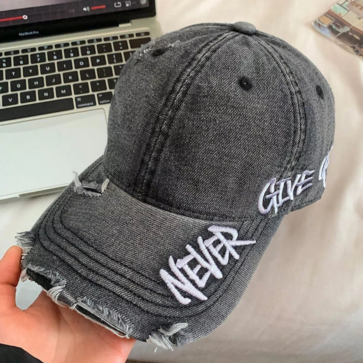 Distressed letter baseball cap shown in black