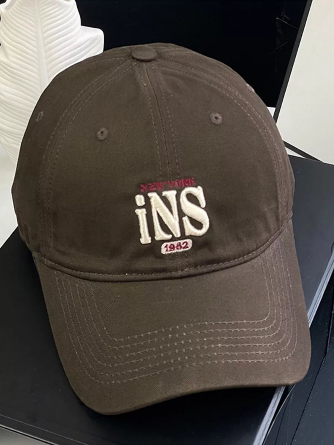 Embroidered baseball cap shown in dark gray