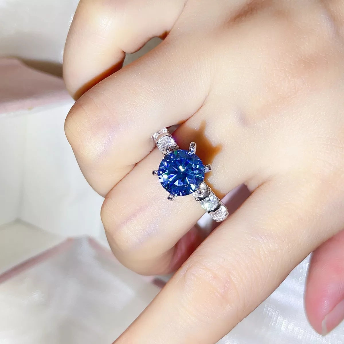Starglow blue moissanite ring in sterling silver on a hand
