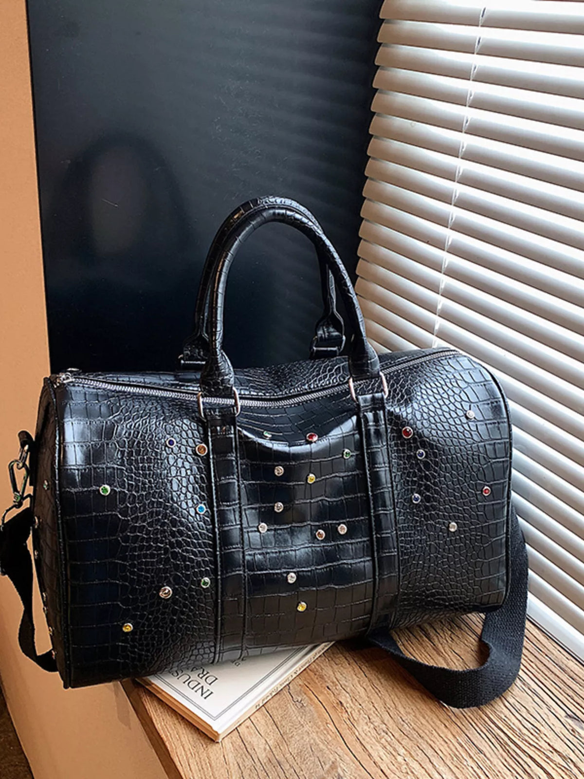 Studded travel bag top handle detail
