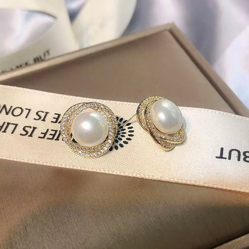 Pearl stud earrings gold close up