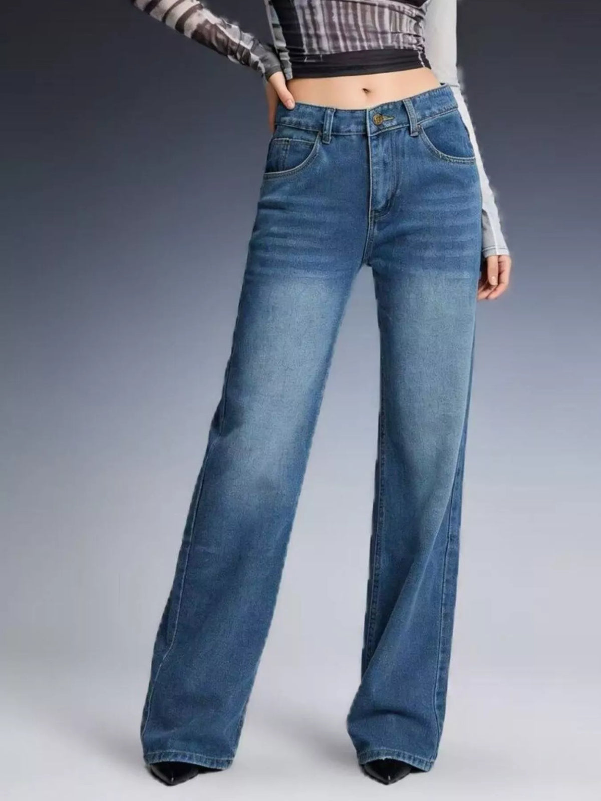 Buttoned closure detail on vintage wash jeans