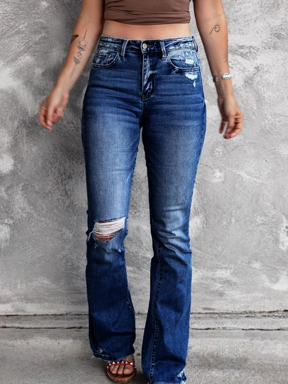 Back view of distressed flare jeans with pockets