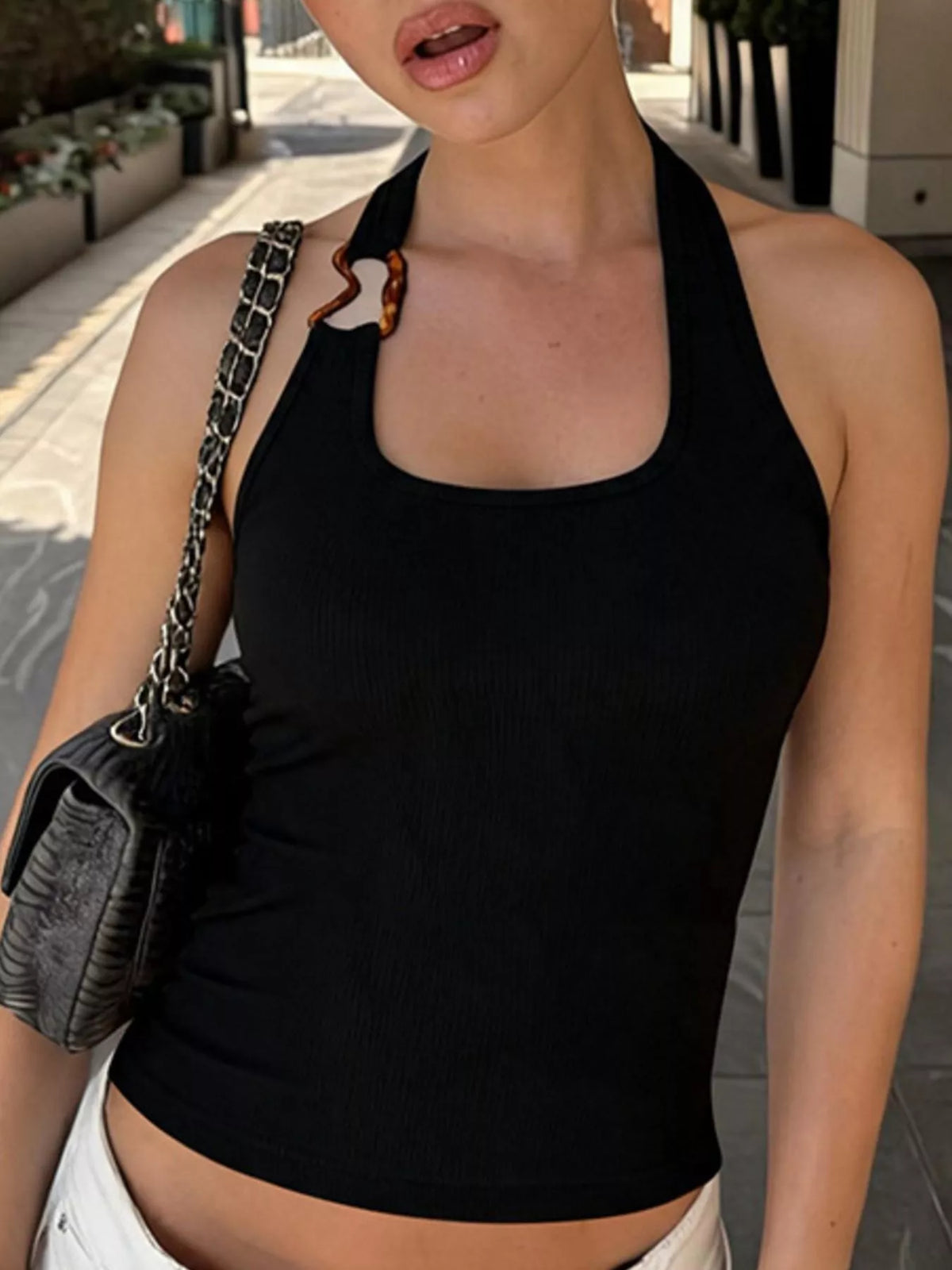 Cropped length of the white ribbed halter tank