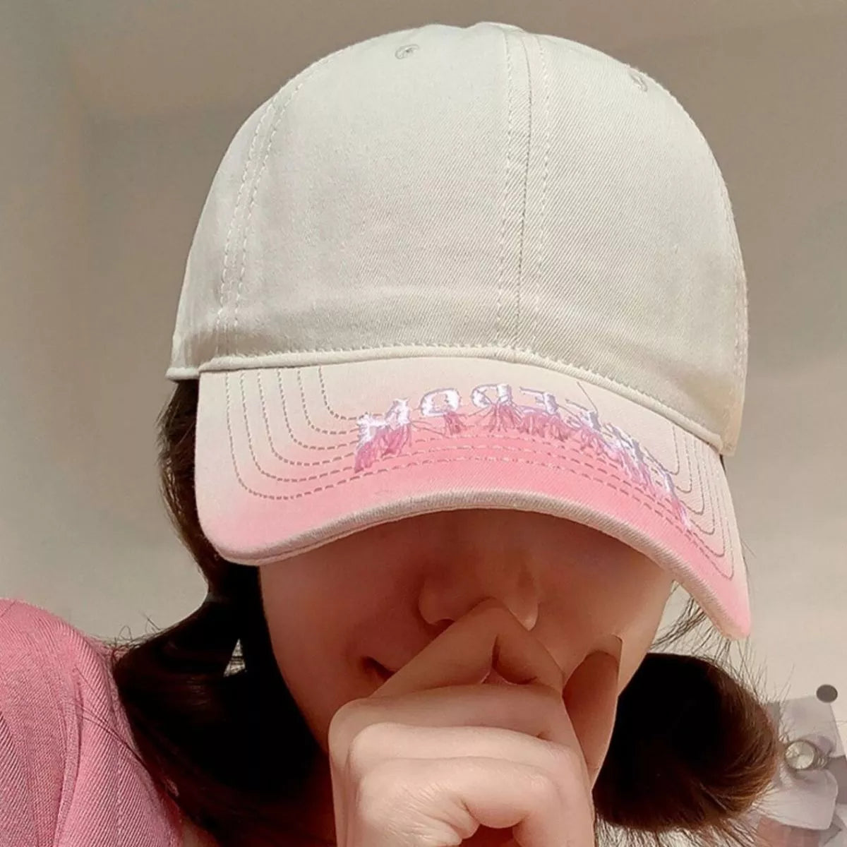 Embroidered baseball cap worn on model