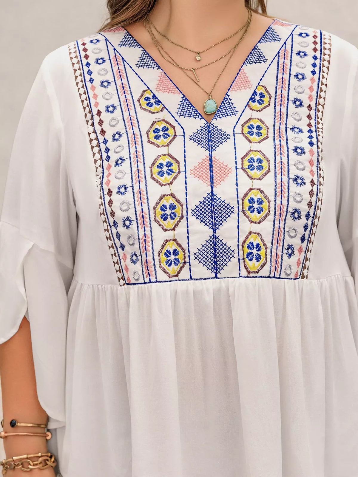Flare sleeve blouse showing geometric print detail
