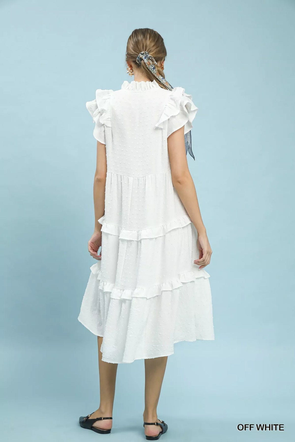 Close view of the ruffle sleeve and textured dot fabric