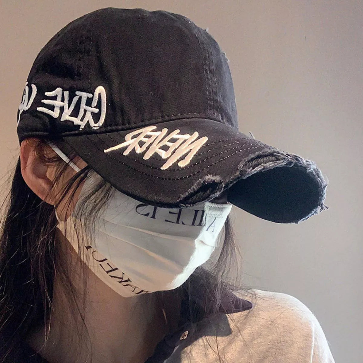 Distressed letter baseball cap shown in wine red