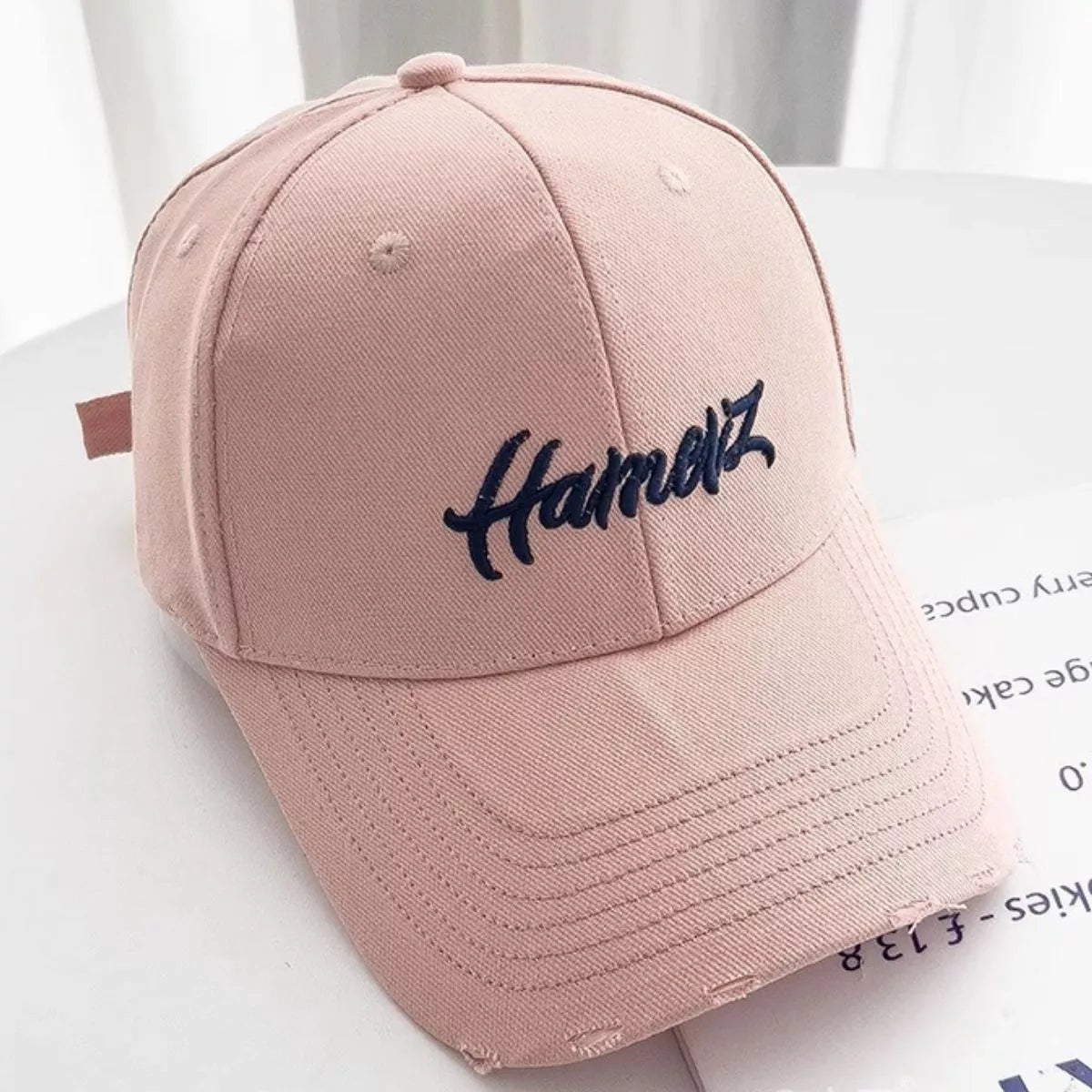 Close up of the distressed fraying on the pink cap