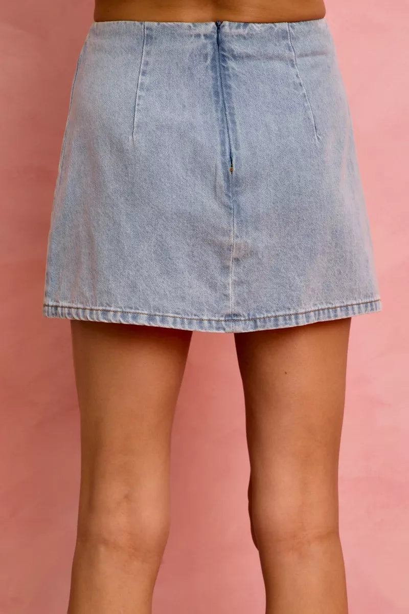 Denim mini skirt with lace ribbon trim styled on model