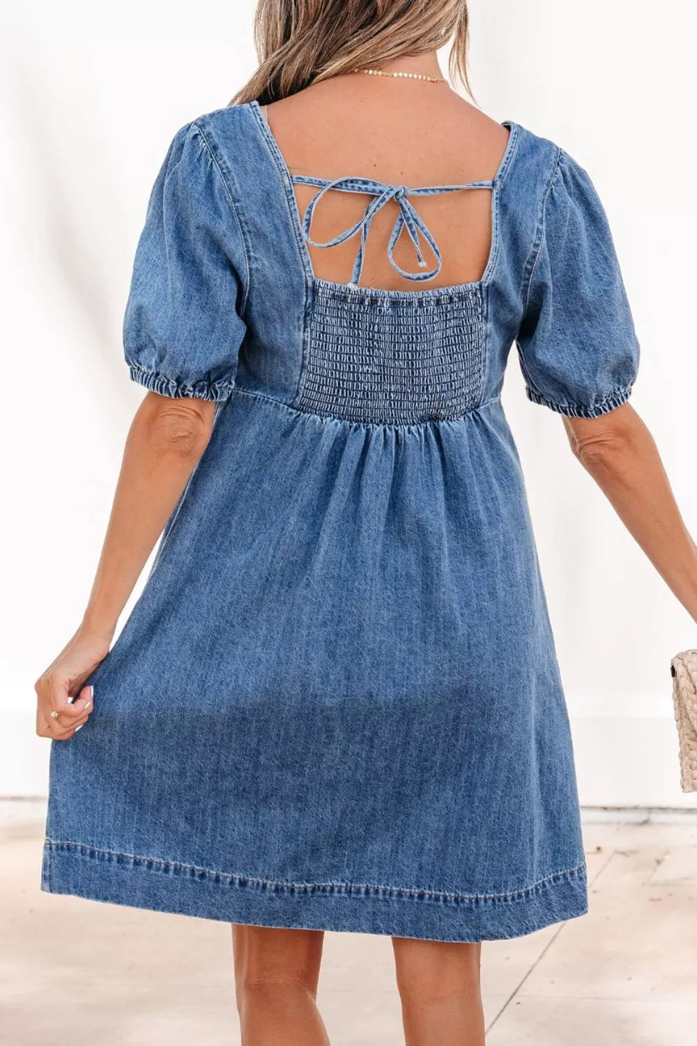 Medium wash button front puff sleeve denim dress, back view
