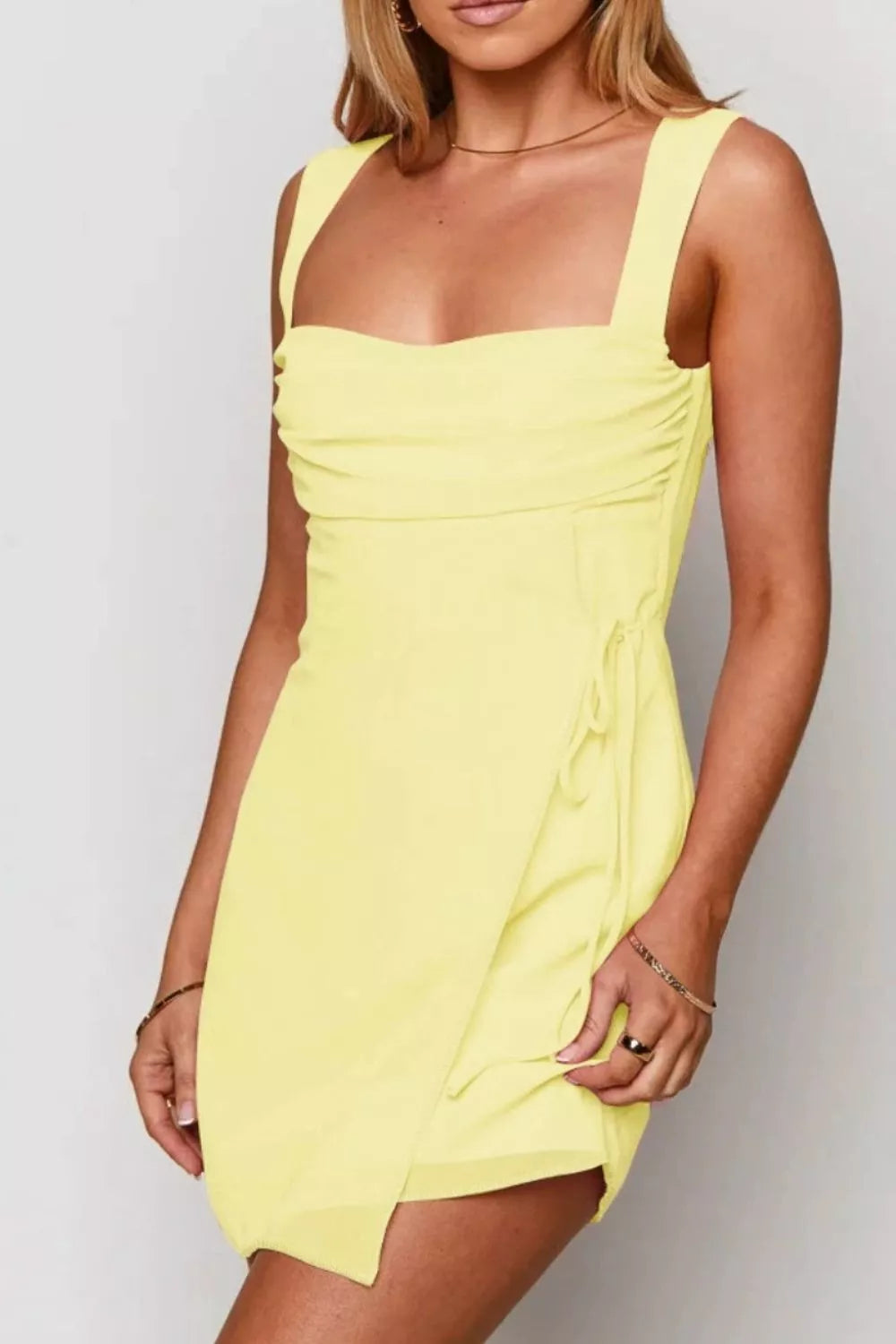 Pastel yellow square neck mini dress three quarter view