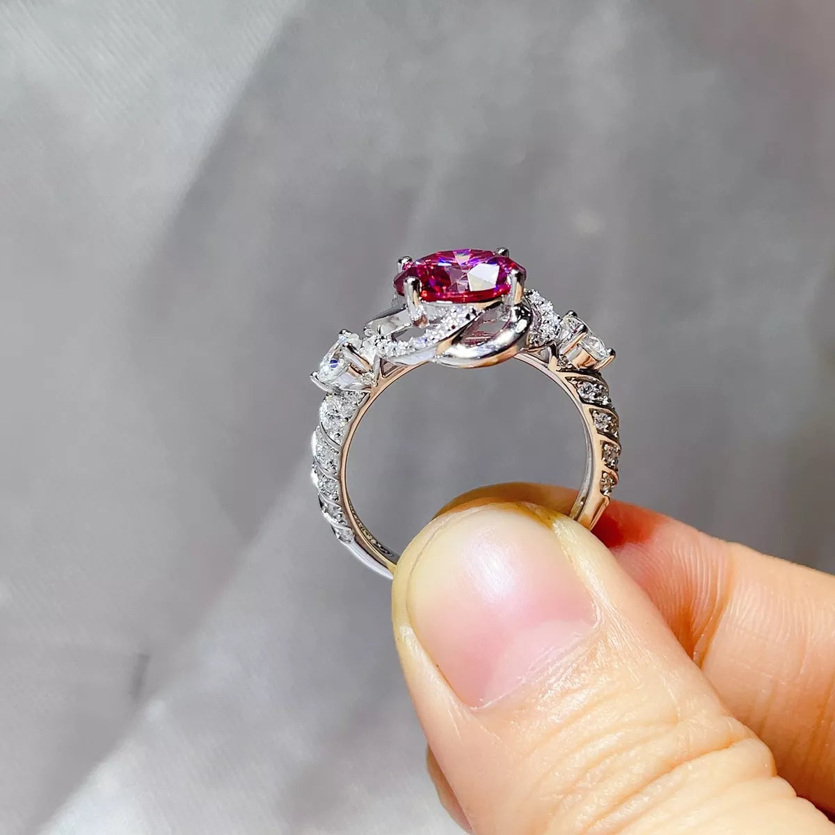 Pink stone ring worn on a hand to show scale