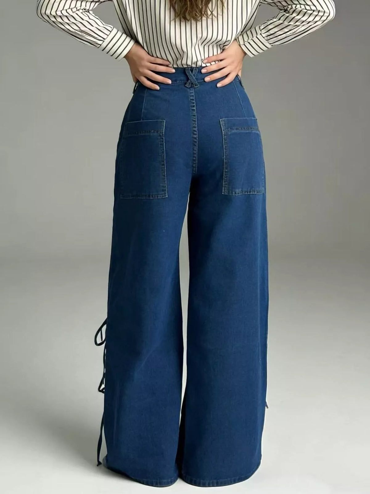 Wide leg hem detail on dark blue jeans