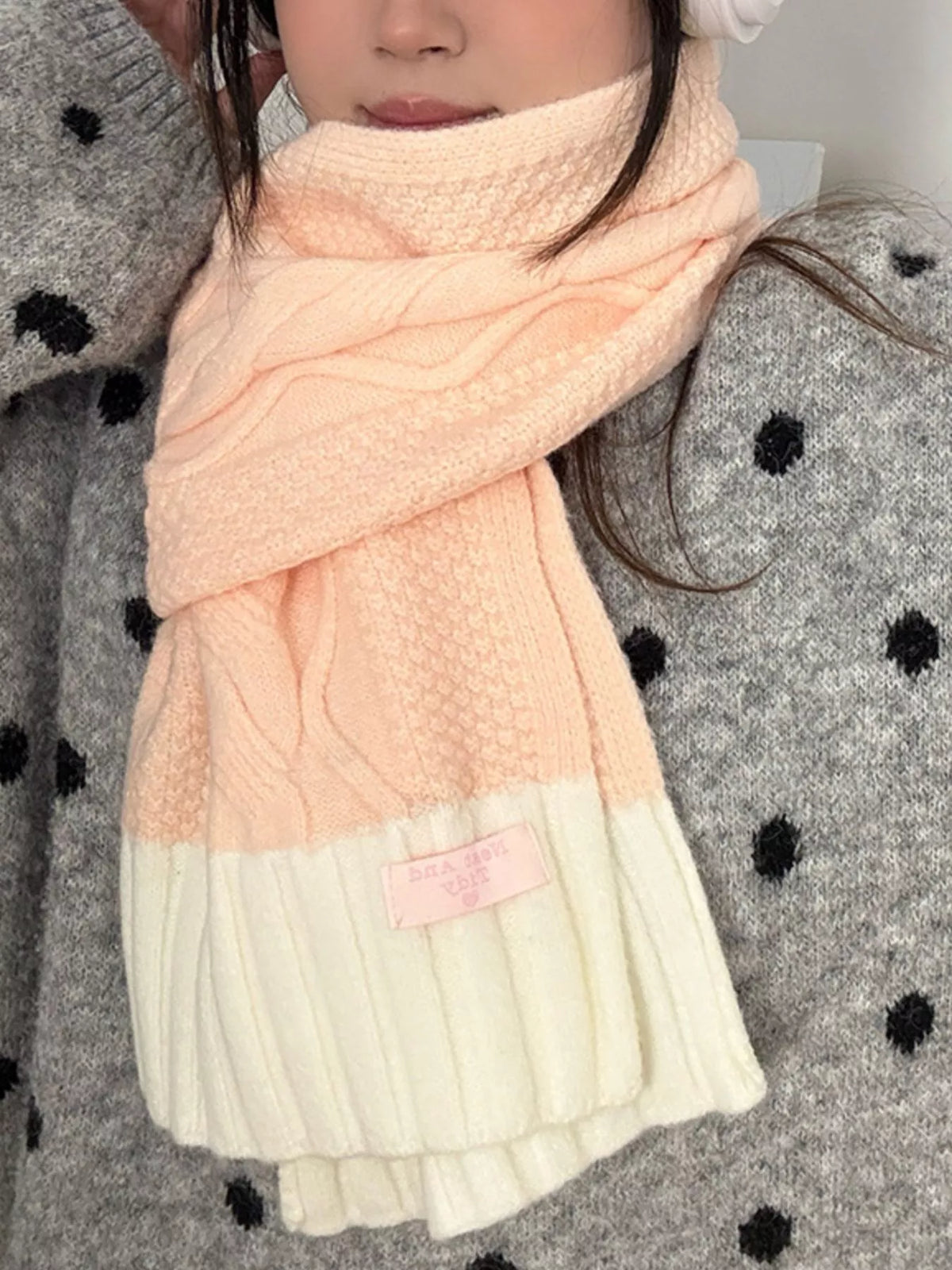 Pink knit scarf with a cozy contrast design