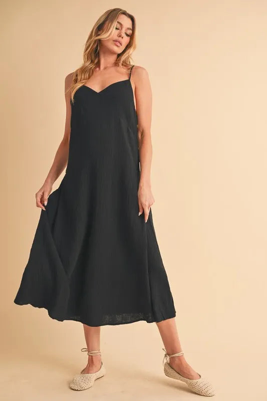 Black side button midi cami dress front view on model