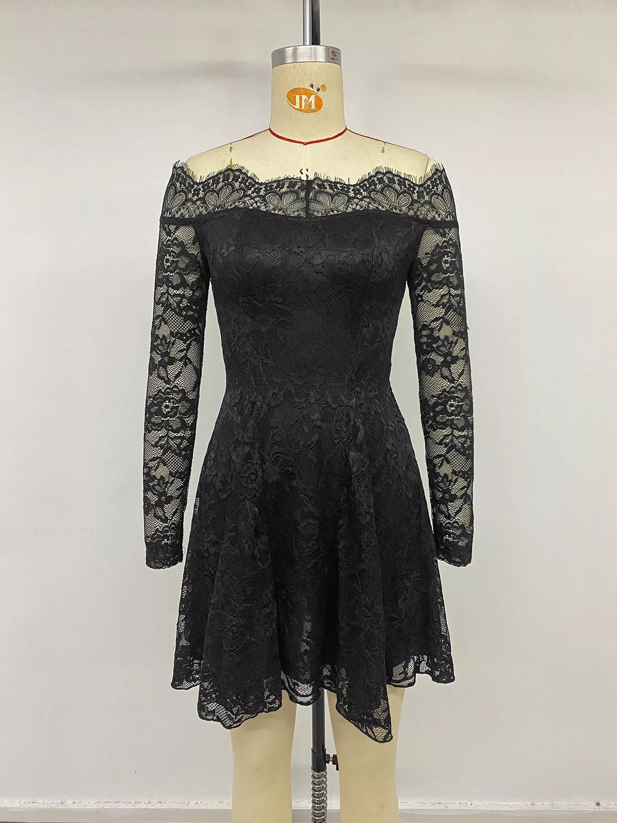 Full length styling shot of the black lace mini dress