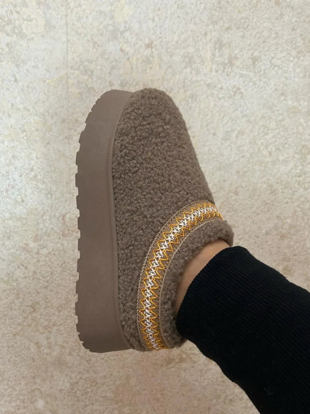 Embroidered trim platform sherpa boots front view