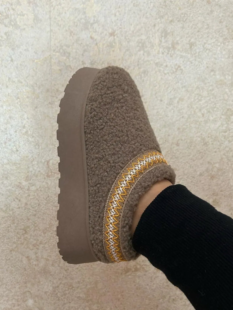 Embroidered trim platform sherpa boots front view