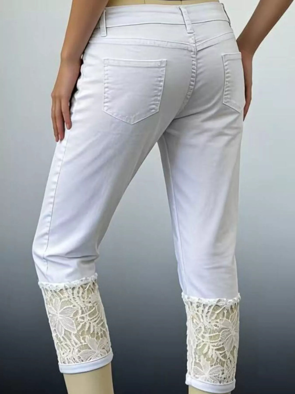 Close up of lace trim on cropped denim