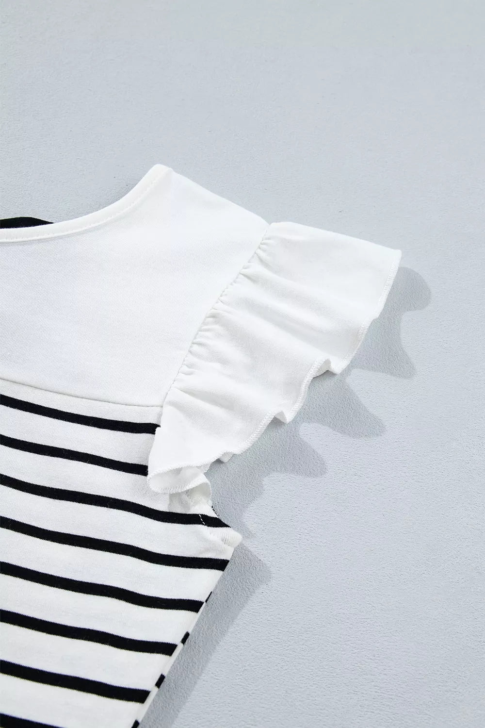 Sleeveless striped top with bow knot back, three quarter view