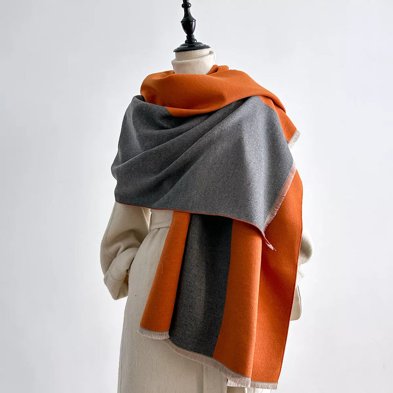 Two tone raw hem scarf draped over the shoulders