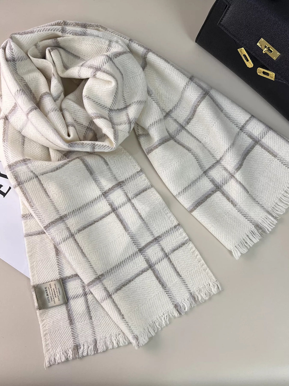 Pure wool plaid scarf draped over a coat