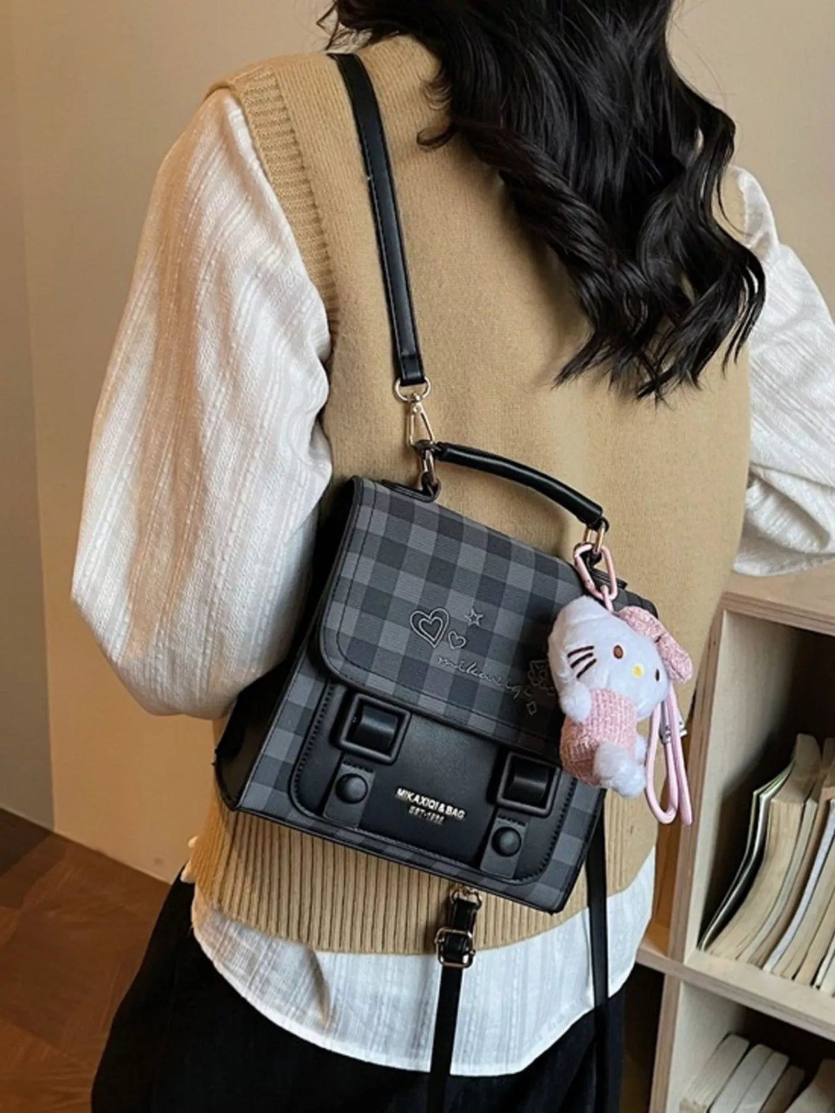 Black plaid embroidered flap mini backpack shoulder strap detail