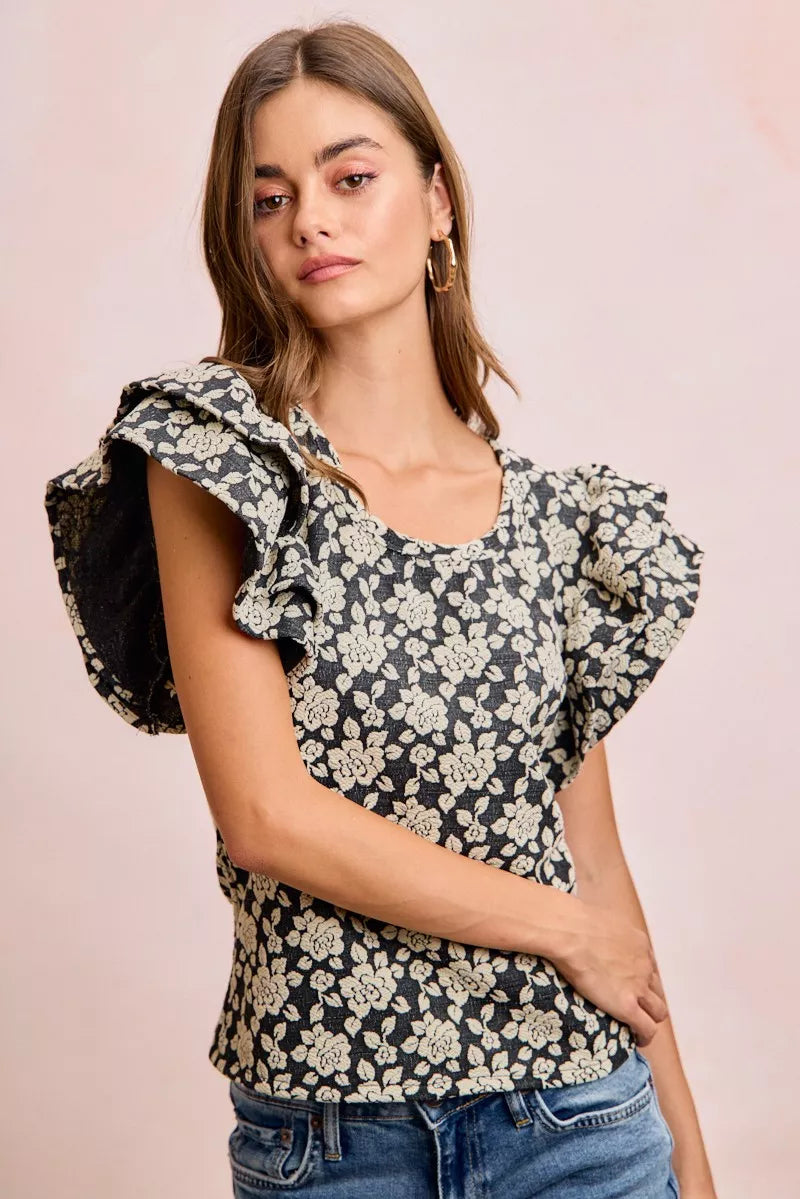 Black and light grey floral ruffle sleeve top back view