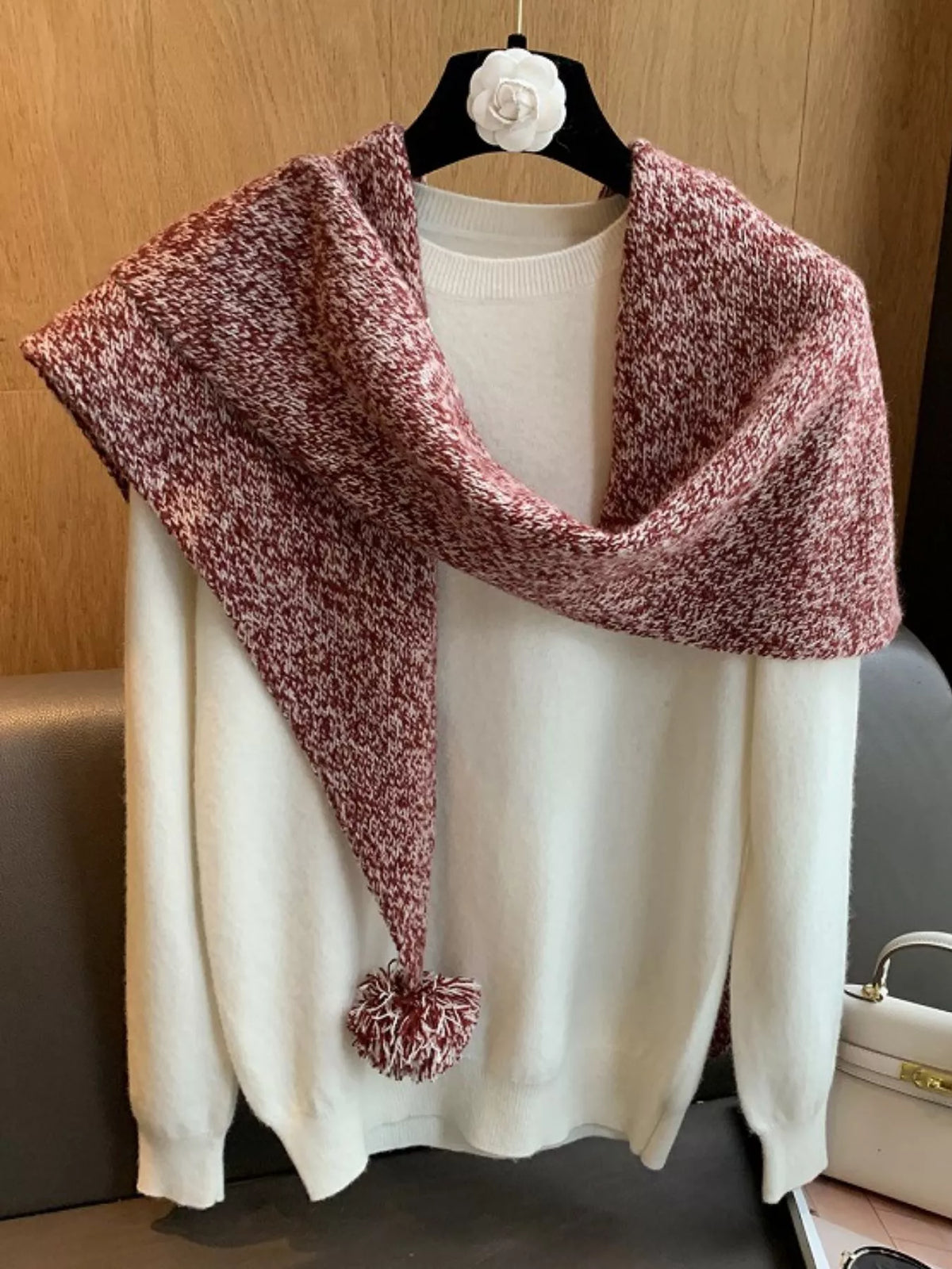Close view of the pom pom trim on the wool scarf