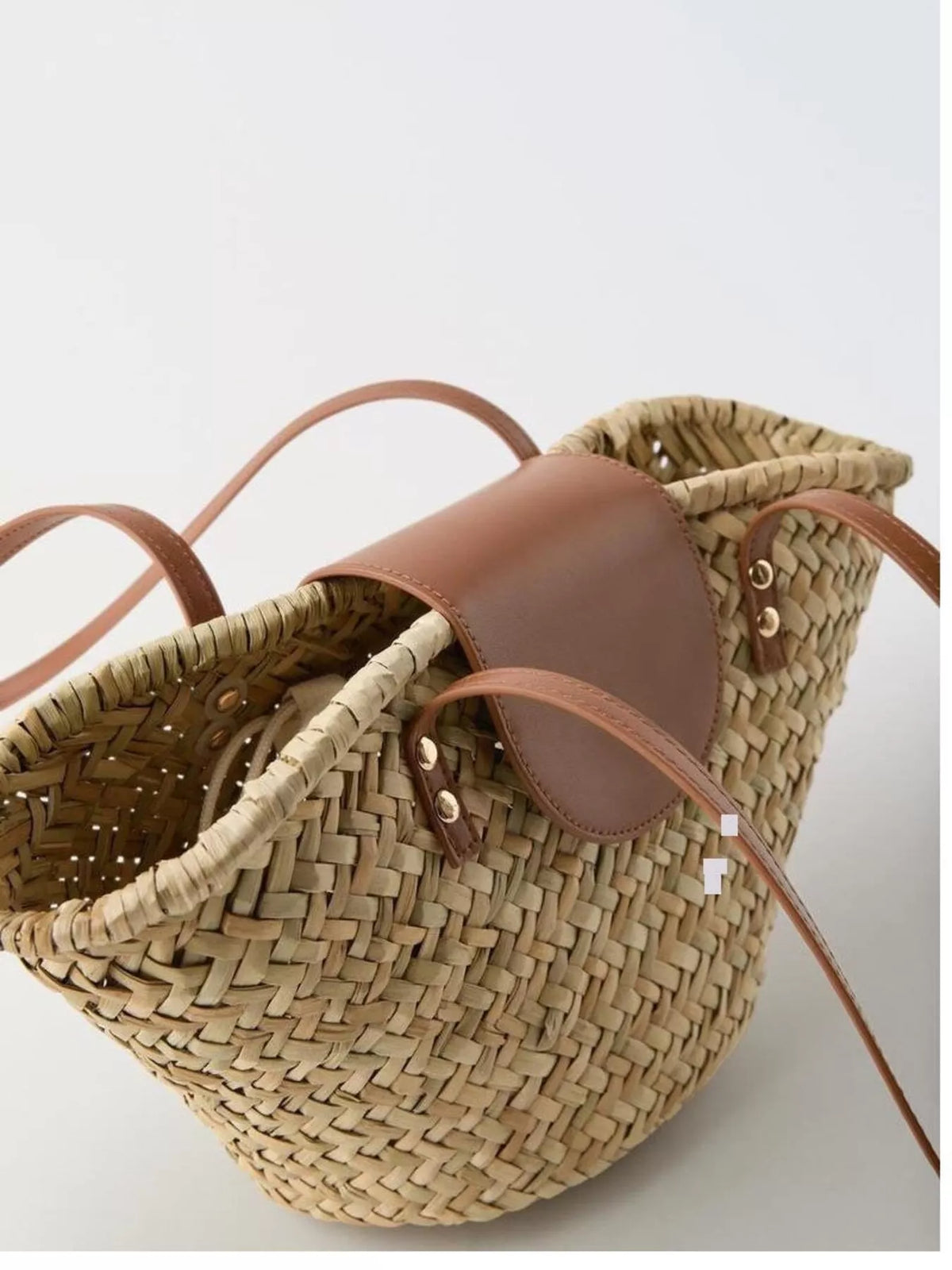 Model carrying woven straw shoulder bag