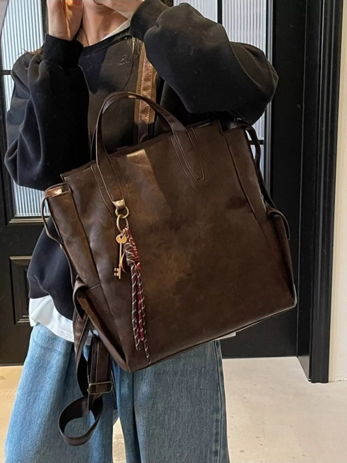 Vintage leather convertible backpack worn on shoulder