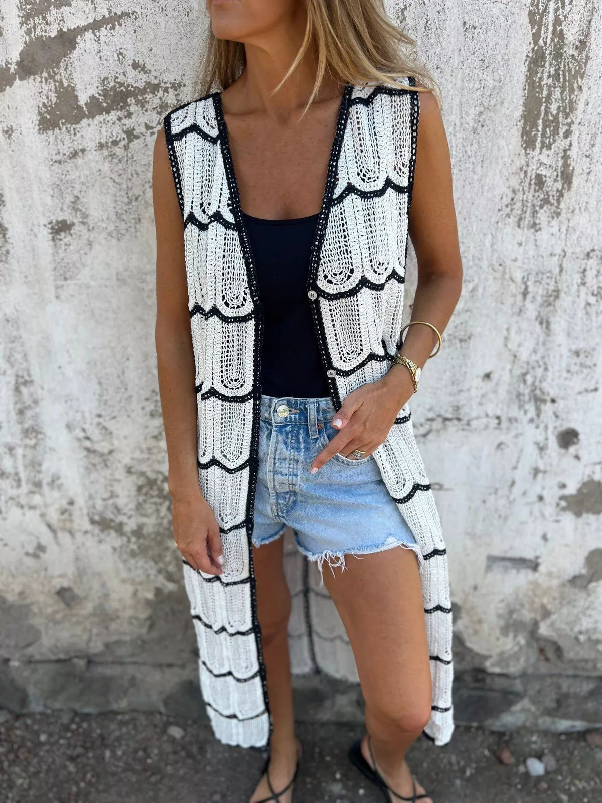 Sleeveless crochet cardigan shown in a warm apricot tone