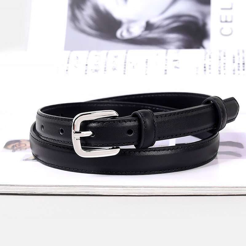 Classic skinny leather belt with silver buckle coiled