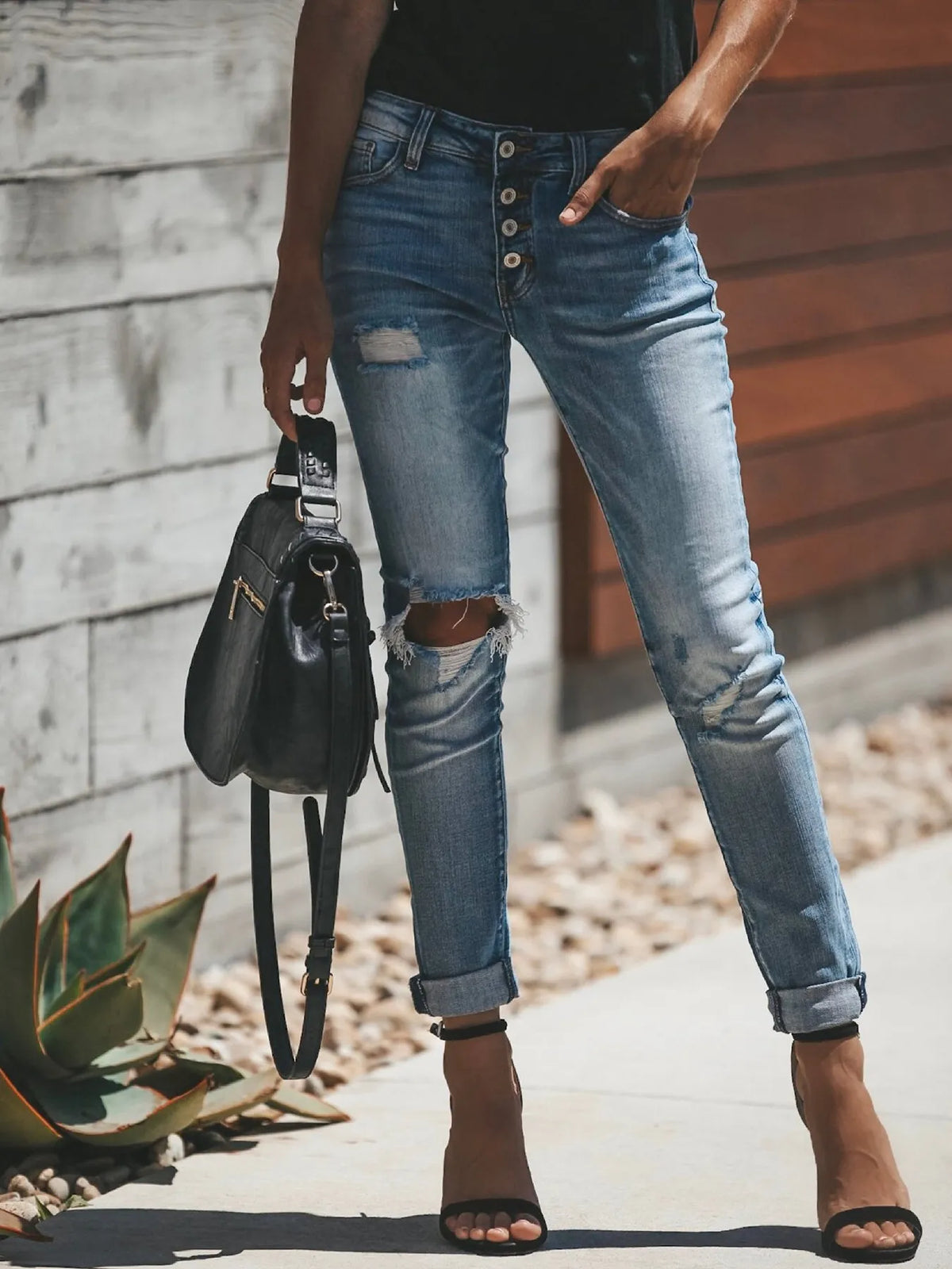 Distressed button fly skinny jeans in light blue front view