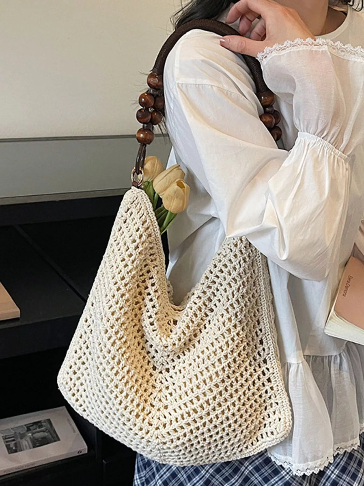 Knitted texture detail on ivory bag