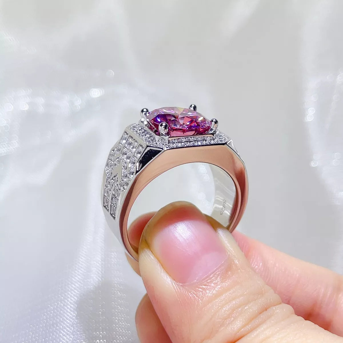 Hot pink moissanite ring shown at an angle to display the setting
