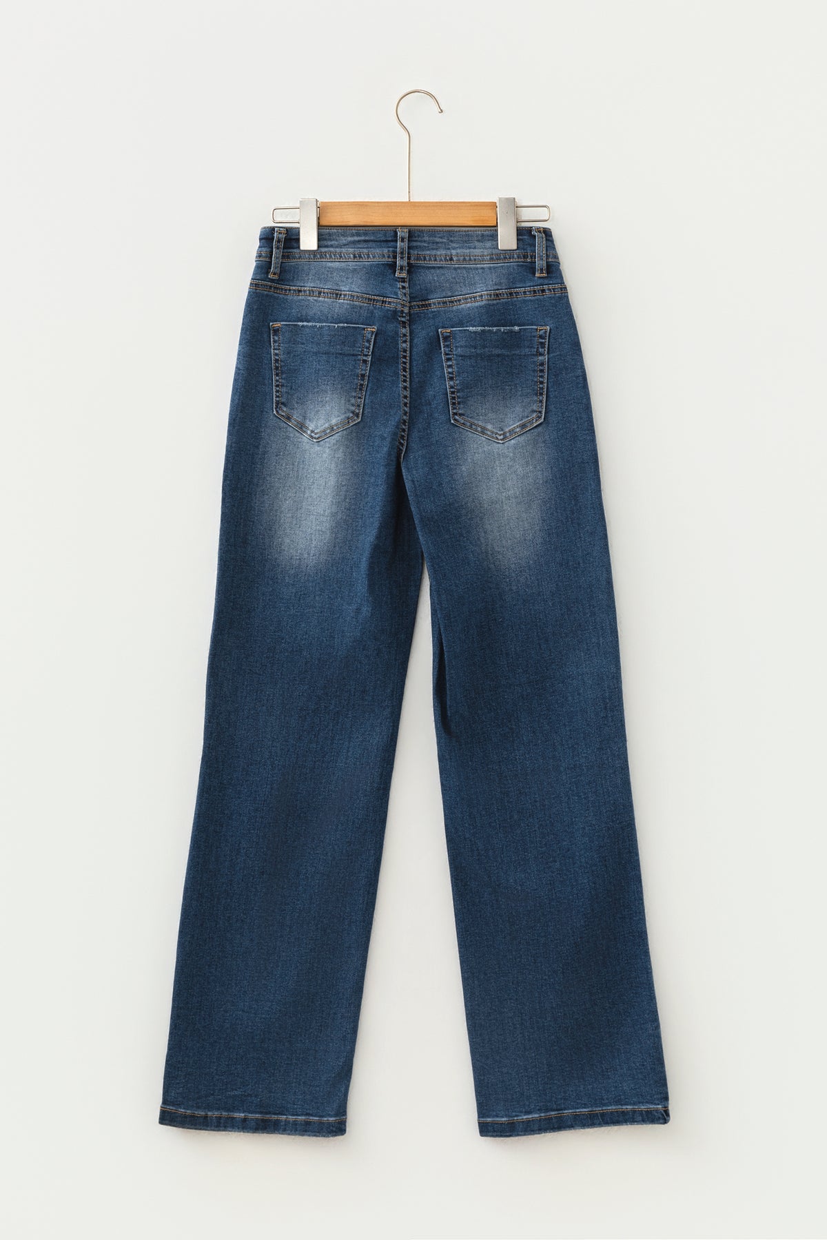 Blue denim jeans styled with boots