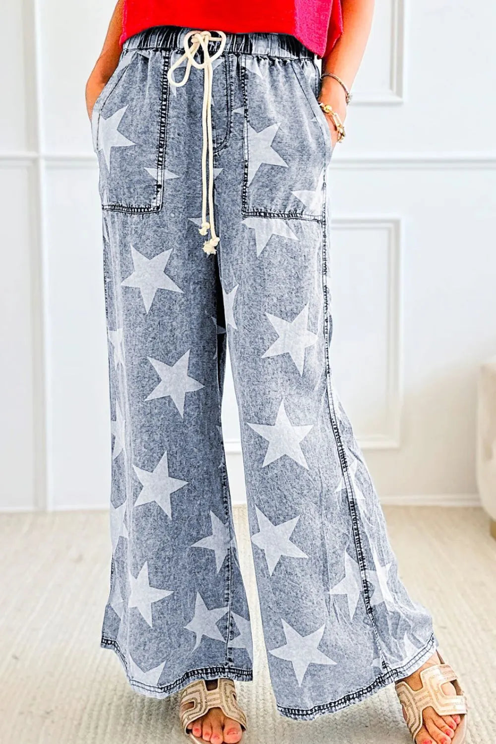 Washed star print jeans showing drawstring waist