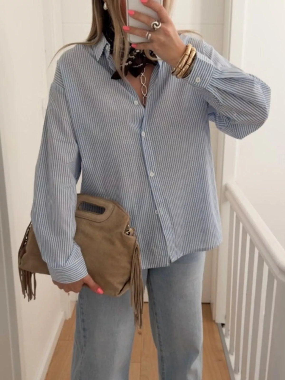 Blue striped shirt with cutout detail shown from the side