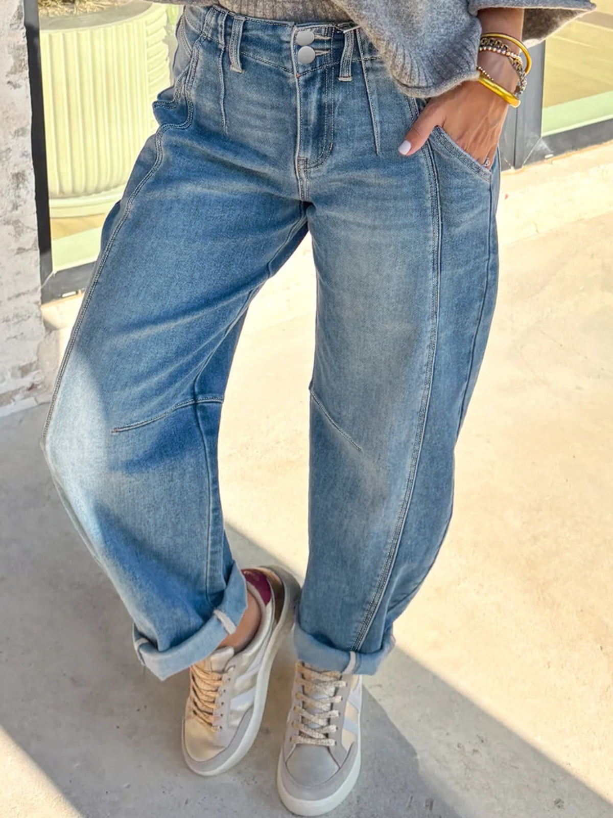 Barrel leg jeans showing curved silhouette on model