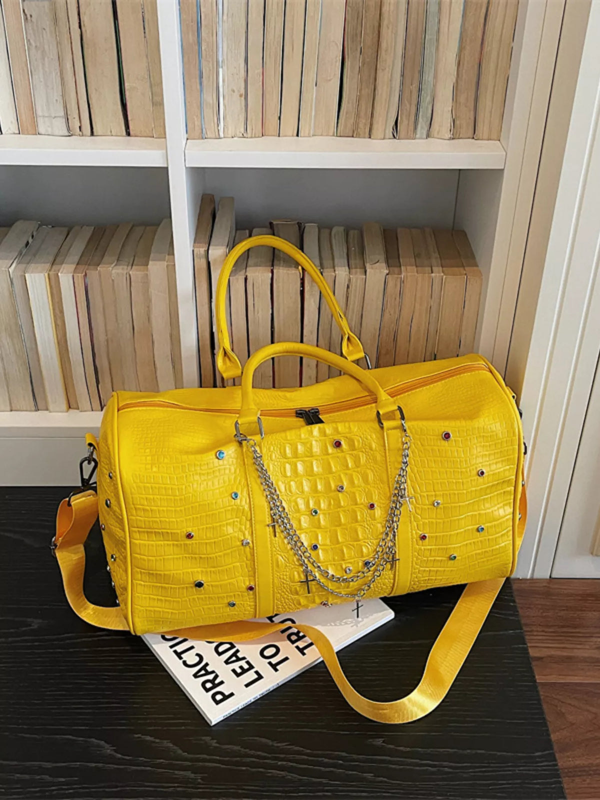 Studded PU leather duffel bag handle detail
