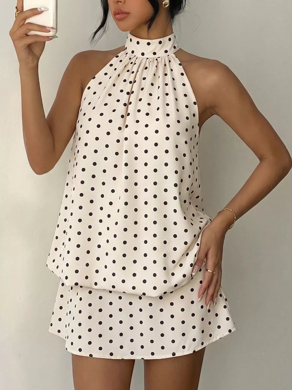 Polka dot halter neck mini dress in apricot, front view