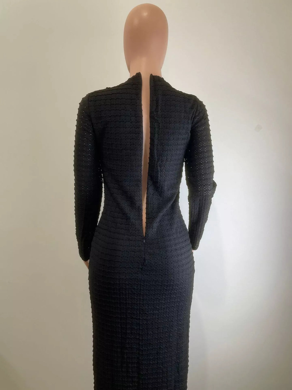 Black textured long dress shown full length on model