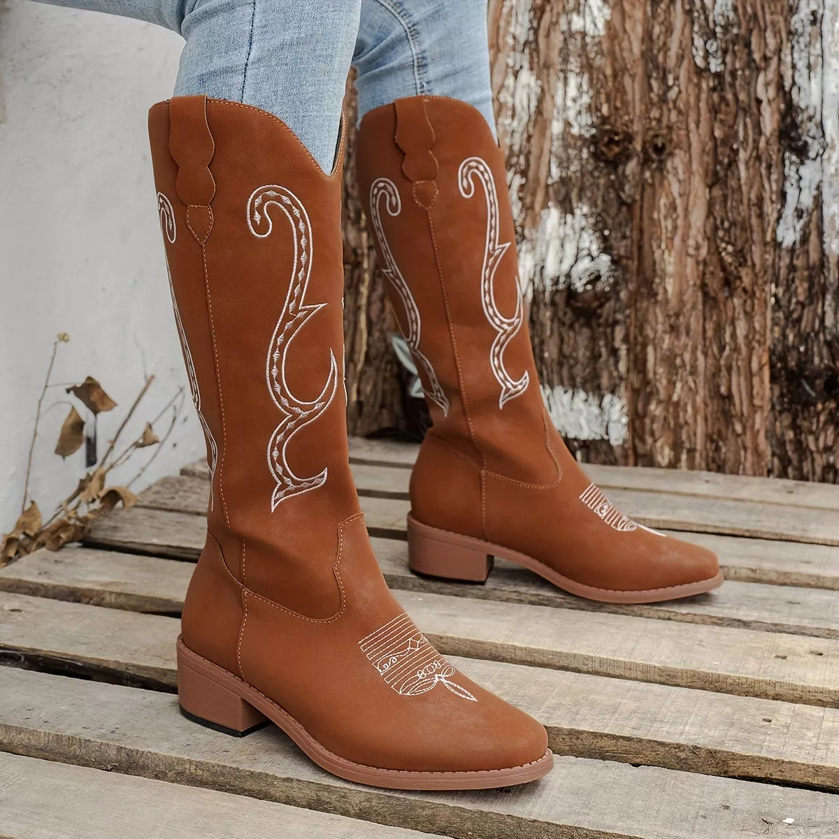 Embroidered round toe block heel boots close up texture