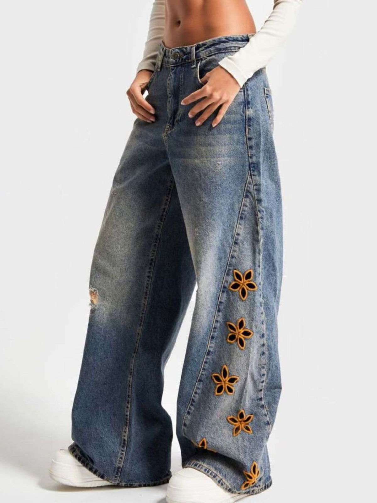 Close up of floral embroidery on denim