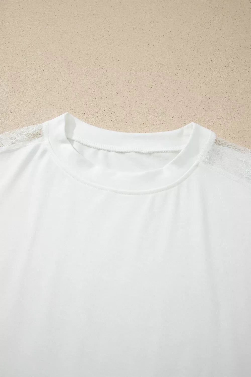 Close view of the lace texture on the white top