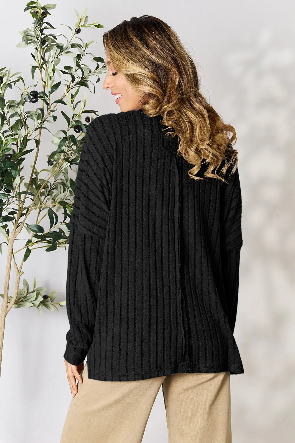 Ribbed knit top side view showing hem slit