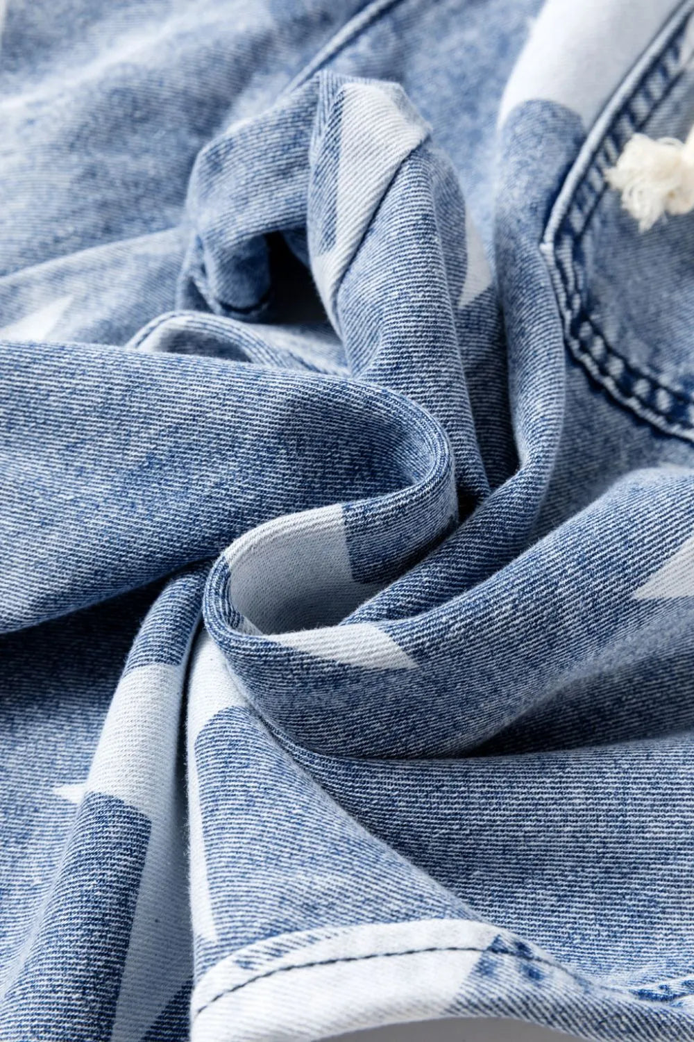 Detail of pocket on star print wide leg jeans