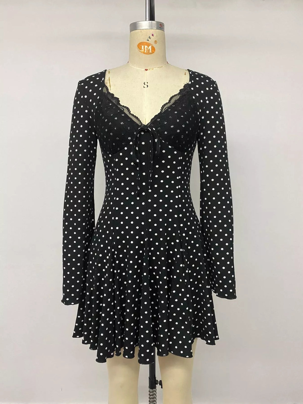 Hem detail on black polka dot mini dress